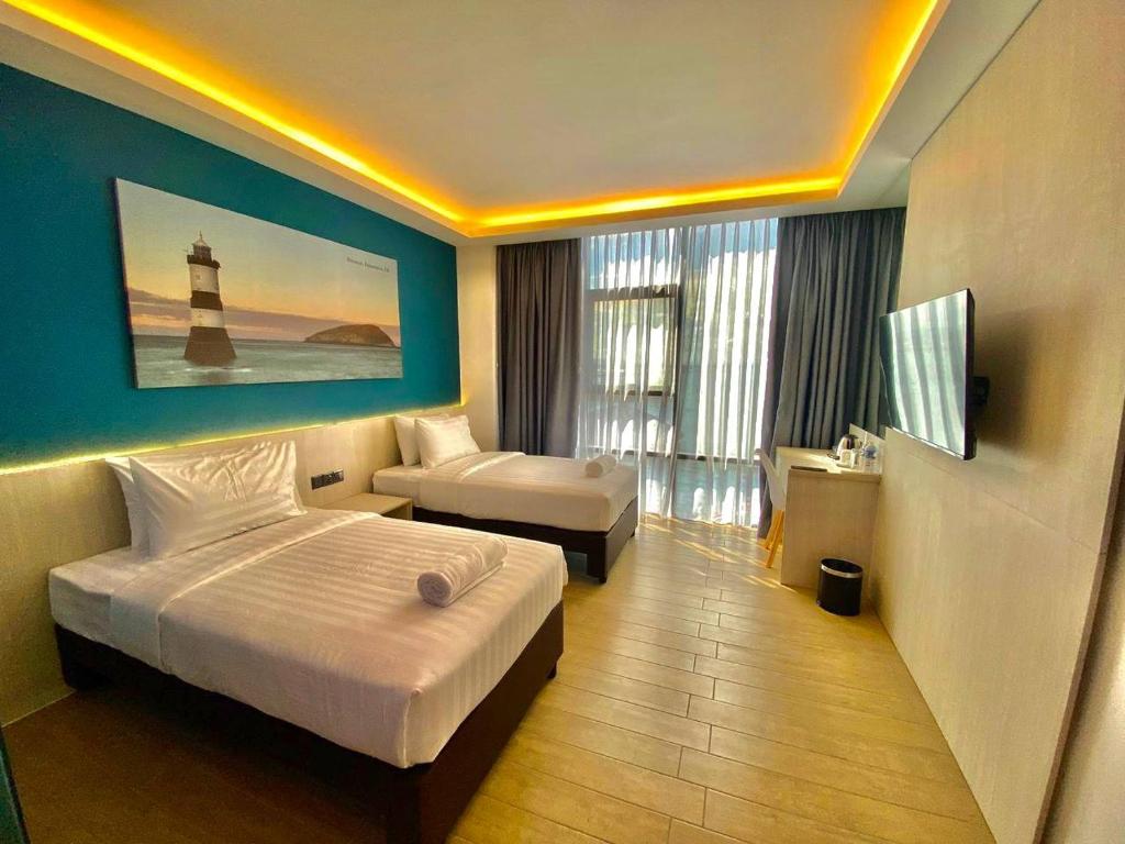 Postel nebo postele na pokoji v ubytování Lighthouse Hotel Semporna