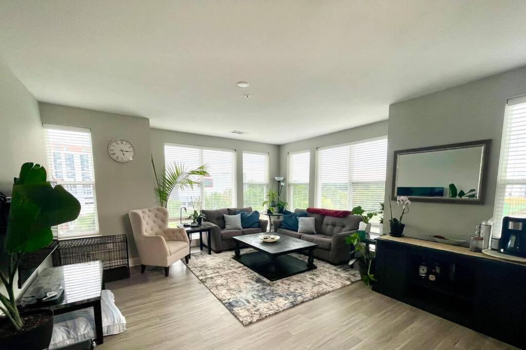 a living room with a couch and chairs and a tv at Luxury 2-Bed 2 Bath Apartment in King of Prussia