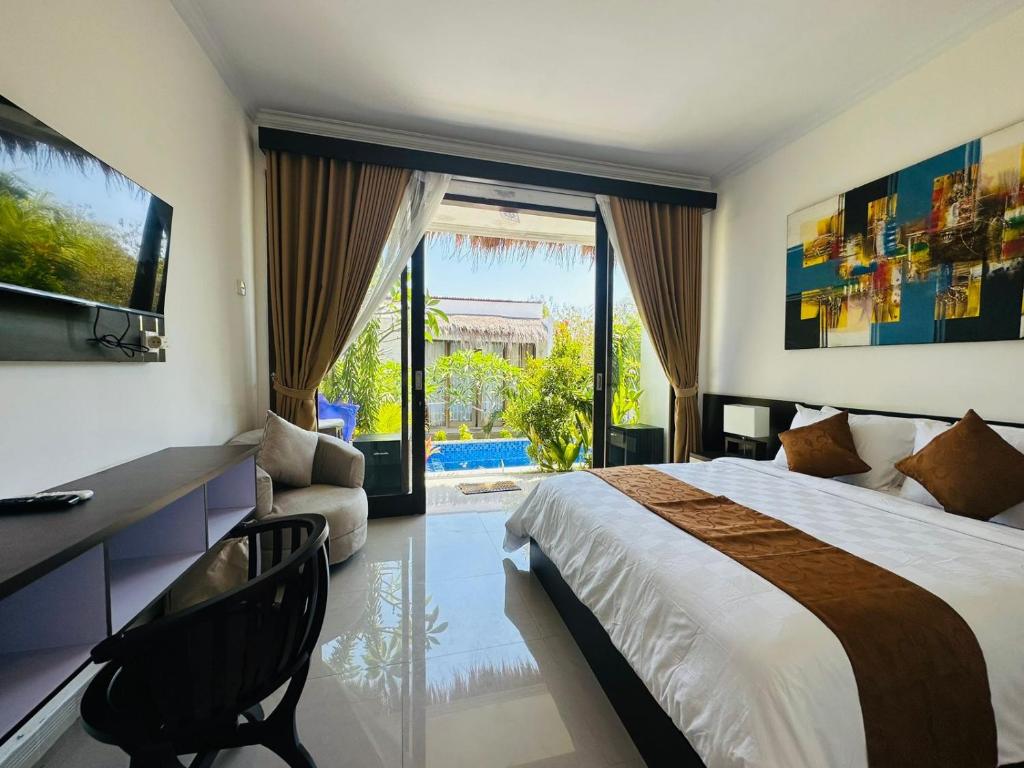 a bedroom with a bed and a desk and a television at Maliqa Villas Nusa Penida in Nusa Penida