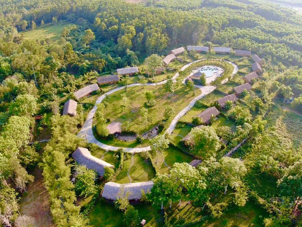 an aerial view of a park with a river and trees at Alba Wellness Resort By Fusion in Hue