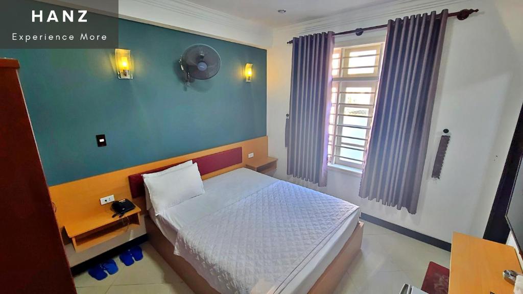 HANZ Minh Ha Hotel tesisinde bir odada yatak veya yataklar