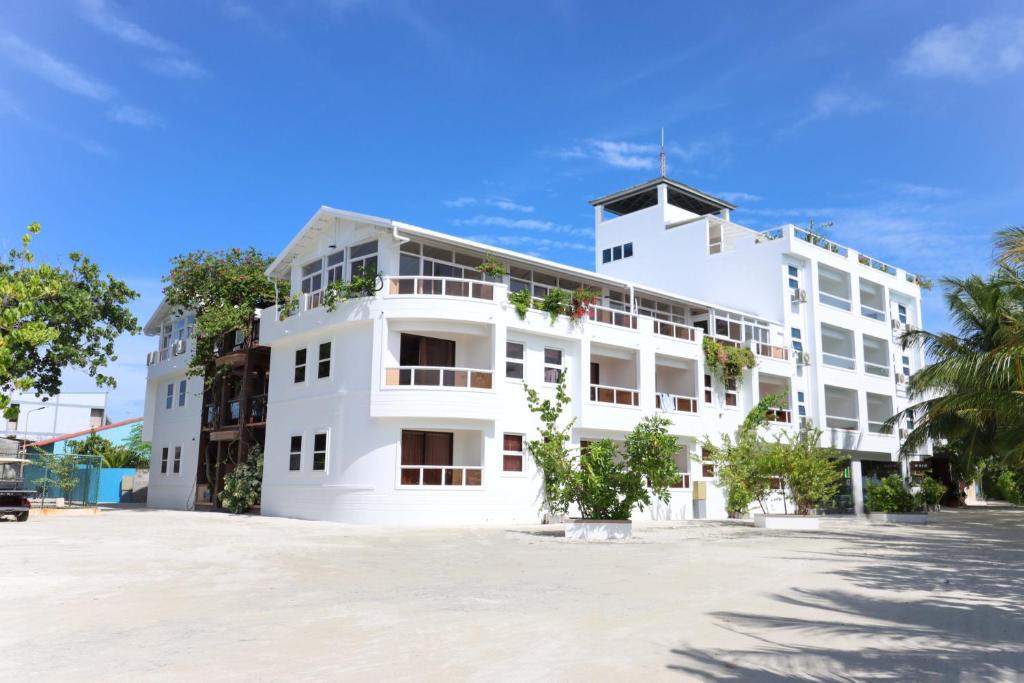 a white building with a lot of windows at Rashu Hiyaa in Dhiffushi