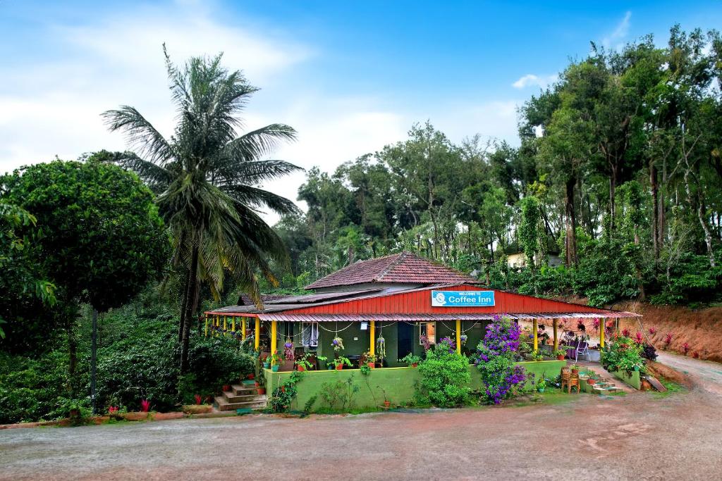 a small store with flowers and a palm tree at CoffeeINN Homestay - Jeep Ride, Water Activities, Home Food in Sakleshpur