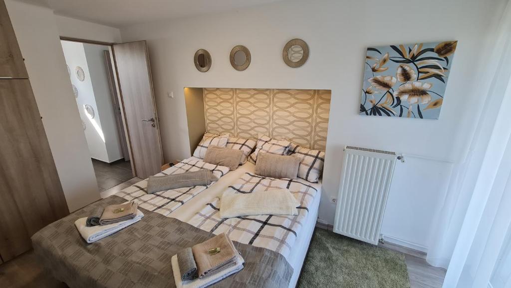 a bedroom with two beds with towels on them at FortunaBeachHouse in Zamárdi