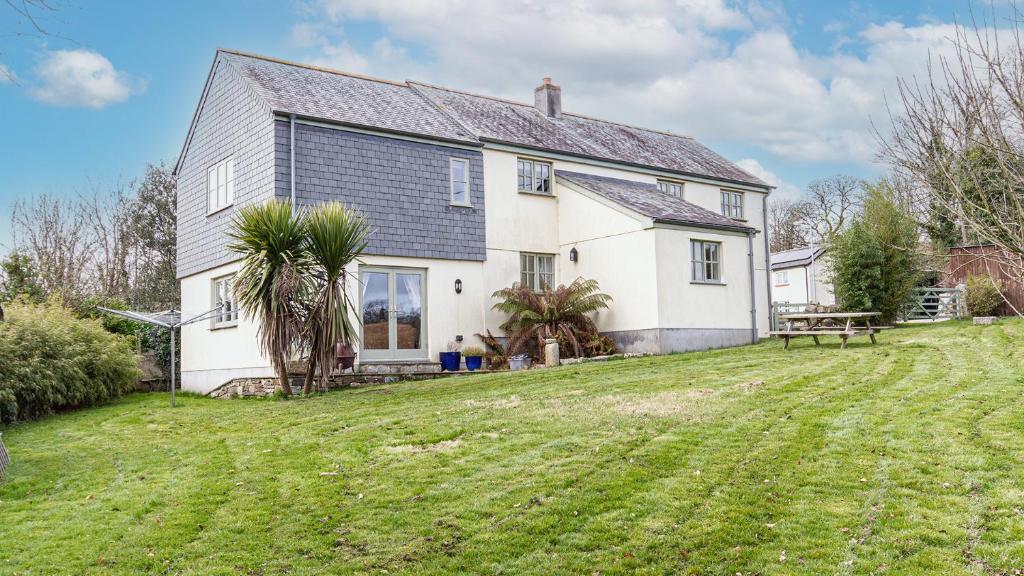 a house with a large yard in front of it at Trelawney Cottage - sleeps 8 - near Wadebridge in Saint Wenn