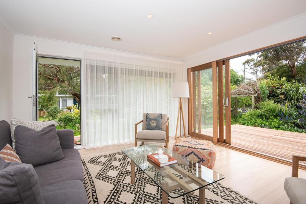 a living room with a couch and a glass table at Blissful Serenity in Somers Walk to the beach in Somers