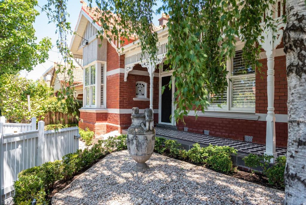 a brick house with a urn in front of it at Stylish Contemporary Retreat St Kilda in Melbourne