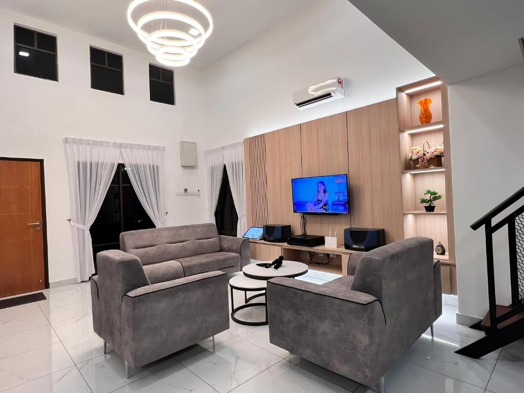a living room with two couches and a tv at TheDot 903 @ A’Famosa Villa NEW VILLA in Kampong Alor Gajah