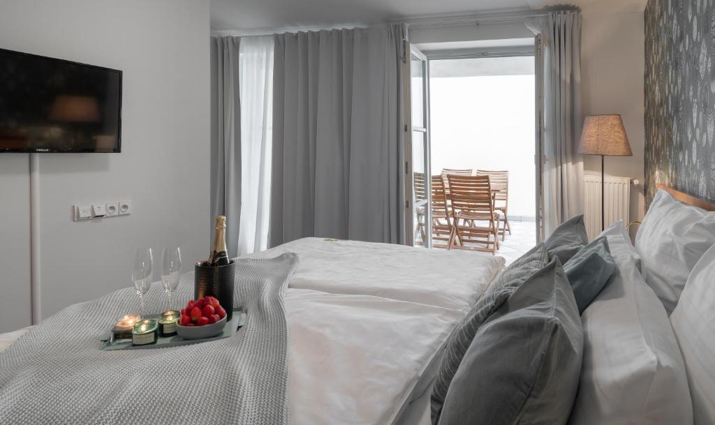 a bedroom with a bed with a bottle of wine and candles at 4 Elements Apartments in Prague