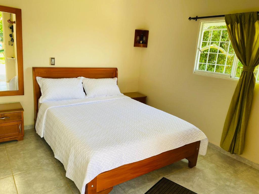 Säng eller sängar i ett rum på Cabaña La Isla