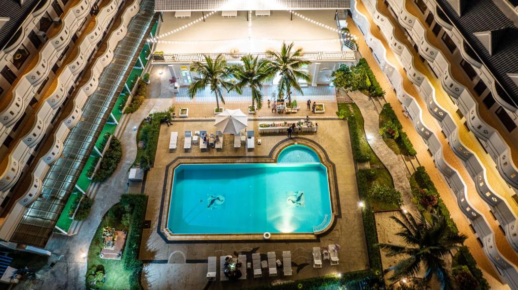 an overhead view of a swimming pool between two buildings at Blue Carina Hotel - SHA Plus in Phuket Town