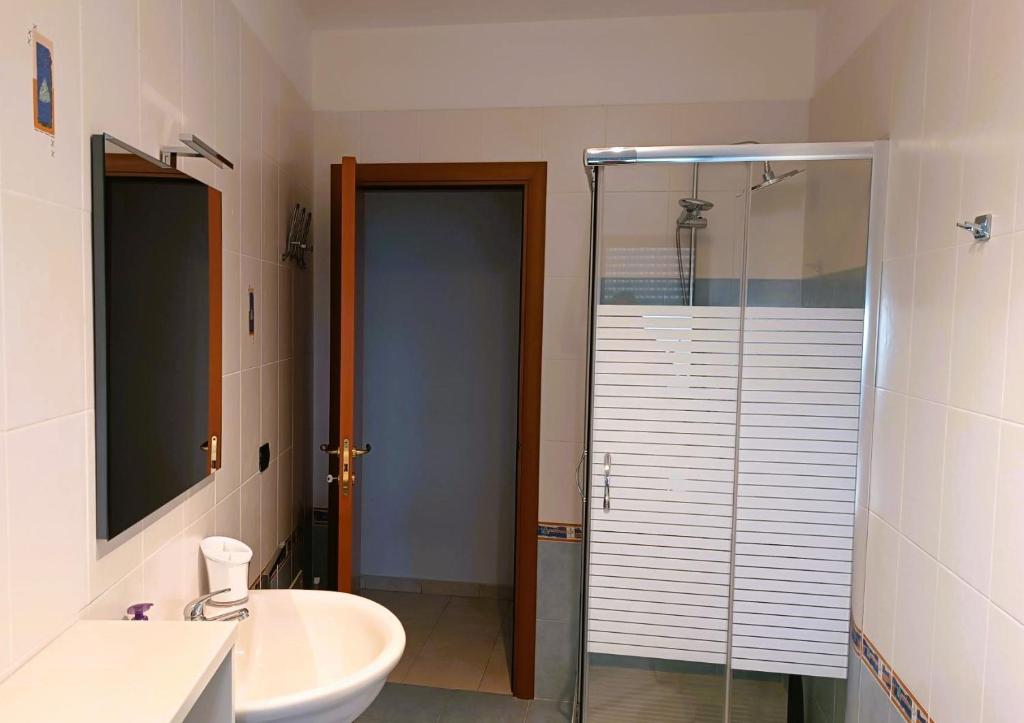 a bathroom with a sink and a glass shower at Pirandello45 - zona universitaria in Campobasso