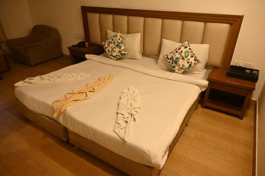 Postel nebo postele na pokoji v ubytování HOTEL SUN GREEN