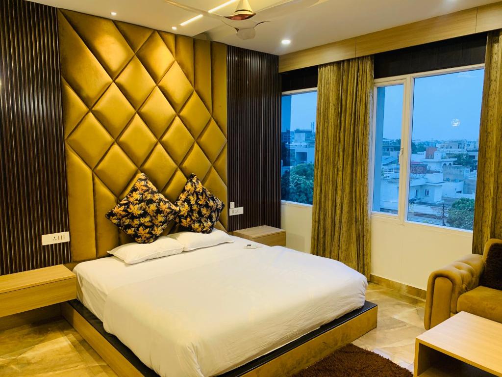 - une chambre avec un lit et une grande fenêtre dans l'établissement HolidayVilla-A Residential Boutique Hotel-Newly Renovated, à Amritsar
