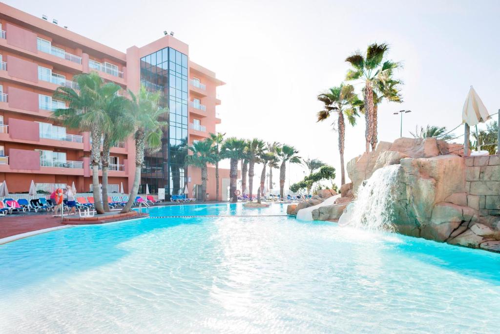 a swimming pool with a waterfall in a resort at Hotel Best Roquetas in Roquetas de Mar