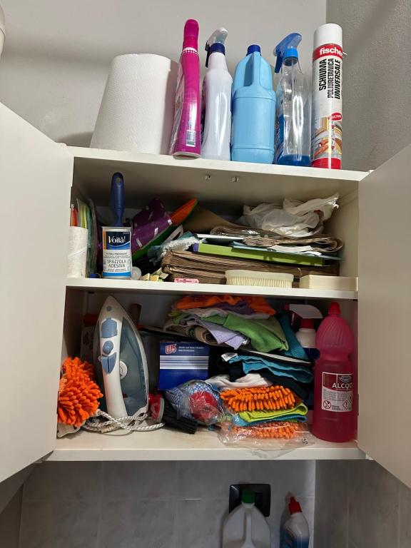 a cupboard filled with lots of items at La tana di Piozzo in Piozzo