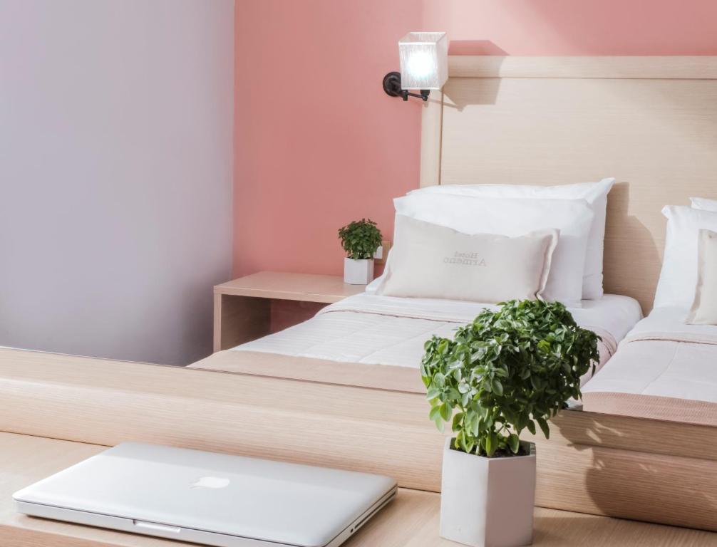 a bedroom with a bed and a laptop on a desk at Armeno beach hotel in Nydri