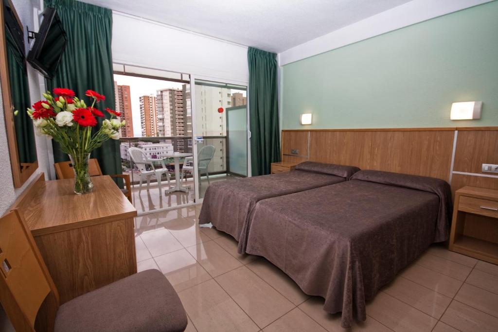 Postel nebo postele na pokoji v ubytování Hotel Perla