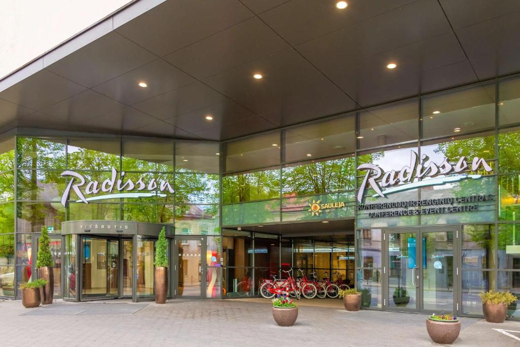 a store front of a shopping center with bikes in the windows at Radisson Hotel Kaunas in Kaunas