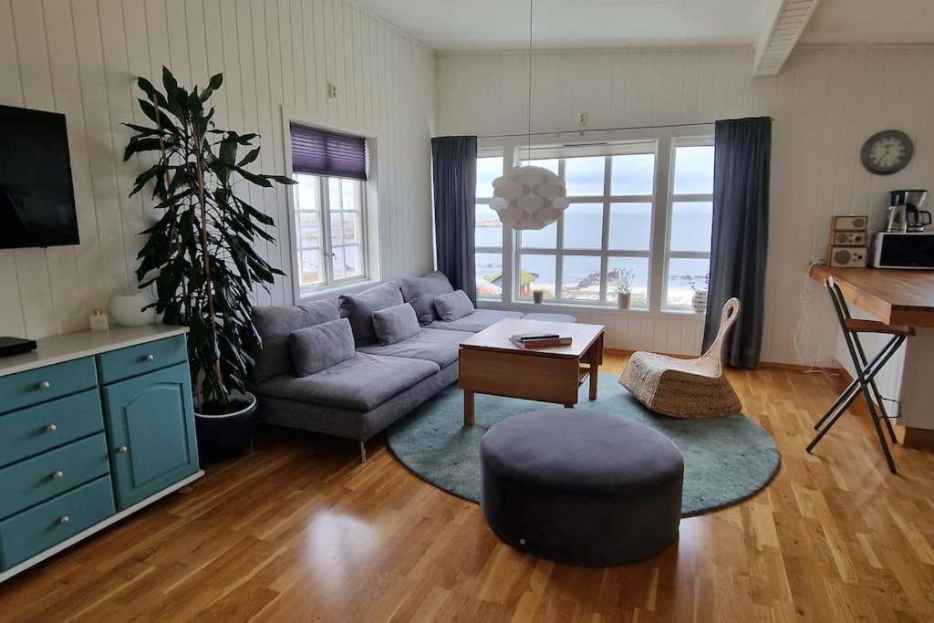 a living room with a couch and a table at Fjøsen - Bleik Beach in Bleik