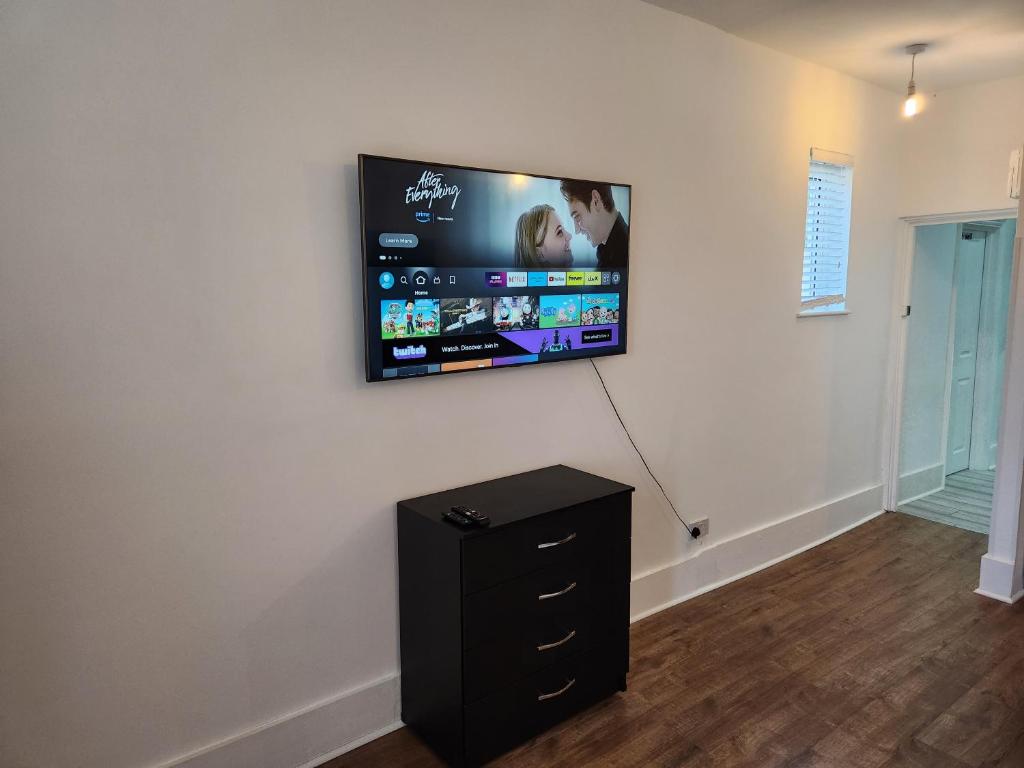 a flat screen tv hanging on a wall at Immaculate 1-Bedroom in Greenhithe in Greenhithe