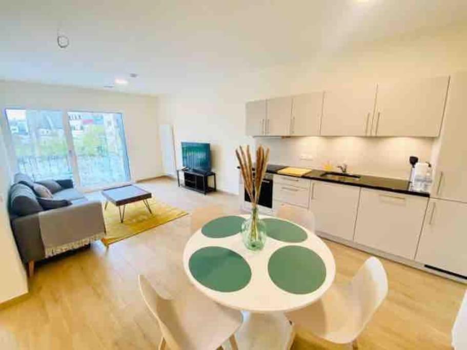 cocina y sala de estar con mesa y sillas. en Luxury 2023 1 bedroom in city center with Free Parking-HOL1, en Luxemburgo