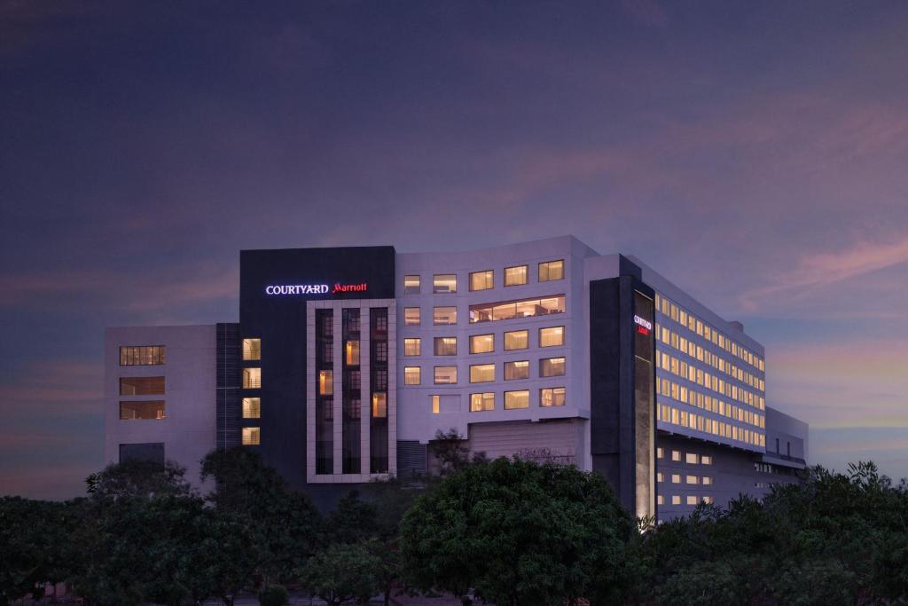 a building with a sign on the side of it at Courtyard by Marriott Bhopal in Bhopal