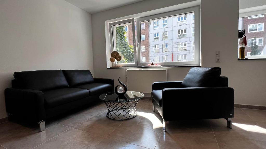 a living room with a couch and a chair at Luxus Appartement im Zentrum Düsseldorfs in Düsseldorf