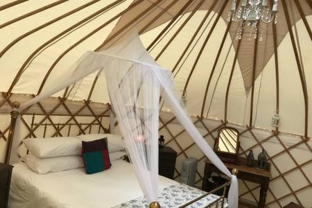 a bedroom with a bed in a yurt at Luxury Yurts in Michaelchurch Escley