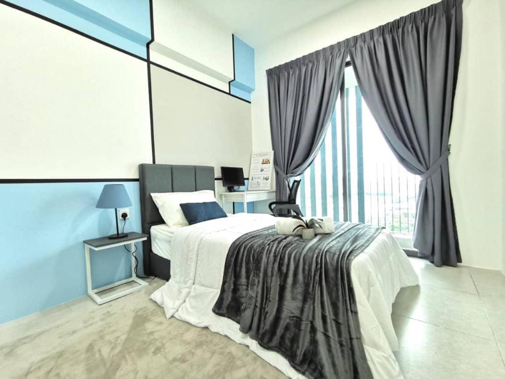 a bedroom with a bed and a large window at Meritus Service Apartment in Perai