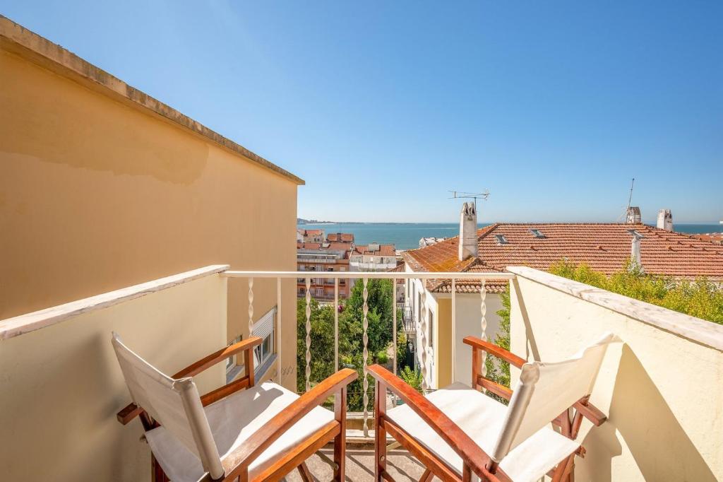a balcony with two chairs and a view of the ocean at GuestReady - Tranquil Algés Getaway in Lisbon