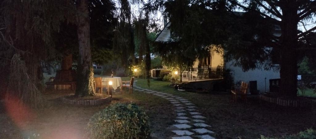 a garden at night with a stone path in front of a house at Les Beaux Sapins 2 in Rochechouart