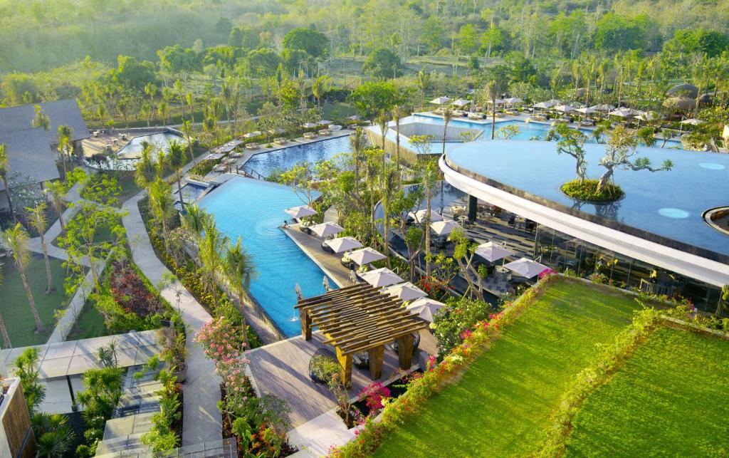 an aerial view of a resort swimming pool with a bench at RIMBA by AYANA Bali in Jimbaran