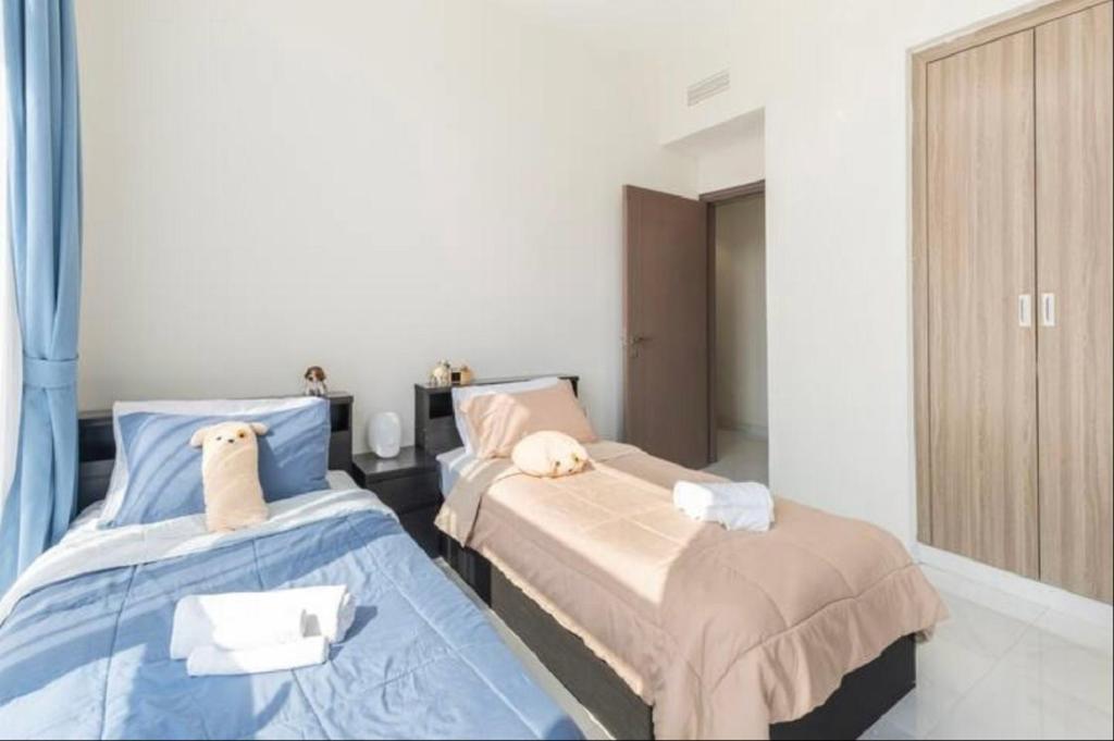 a bedroom with two beds and a window at Private Room in Bright & Cozy Apt Near Downtown, Near Metro, Pool, Gym in Dubai