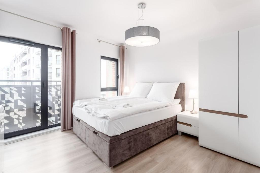 Posteľ alebo postele v izbe v ubytovaní Rent like home - Dwie Motławy III z parkingiem