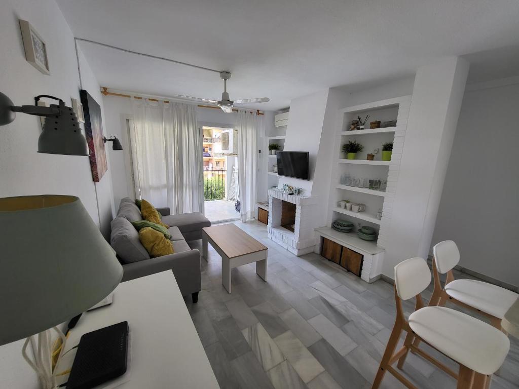 a living room with a couch and a table at Apt Erisa en Torremolinos dos min de la playa, Puerto Marina in Torremolinos