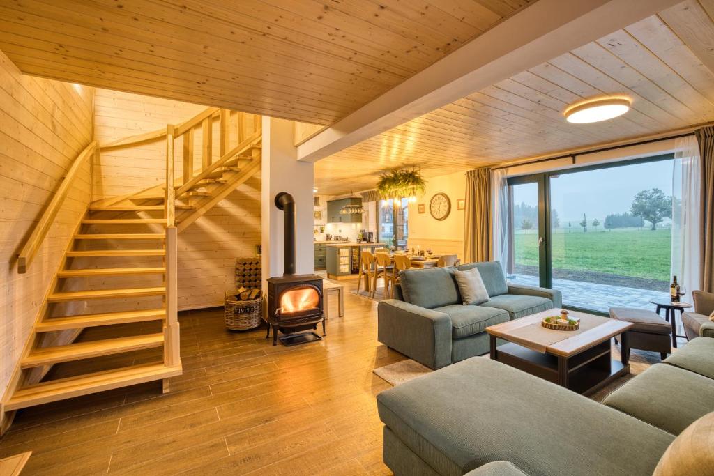 a living room with a staircase in a house at Chalupa Na Rejvízu 