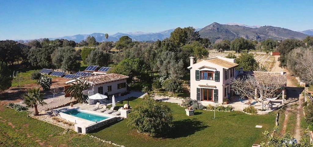 an aerial view of a house with a swimming pool at Los Dos Caballeros Winery & Vacation Rental in Llubí