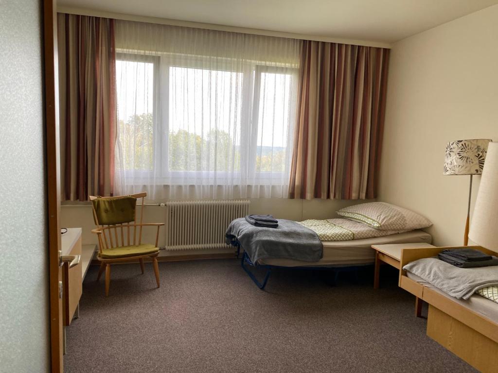 a hotel room with a bed and a window at Gemütliche 1 Zimmerwohnung in Sankt Radegund bei Graz