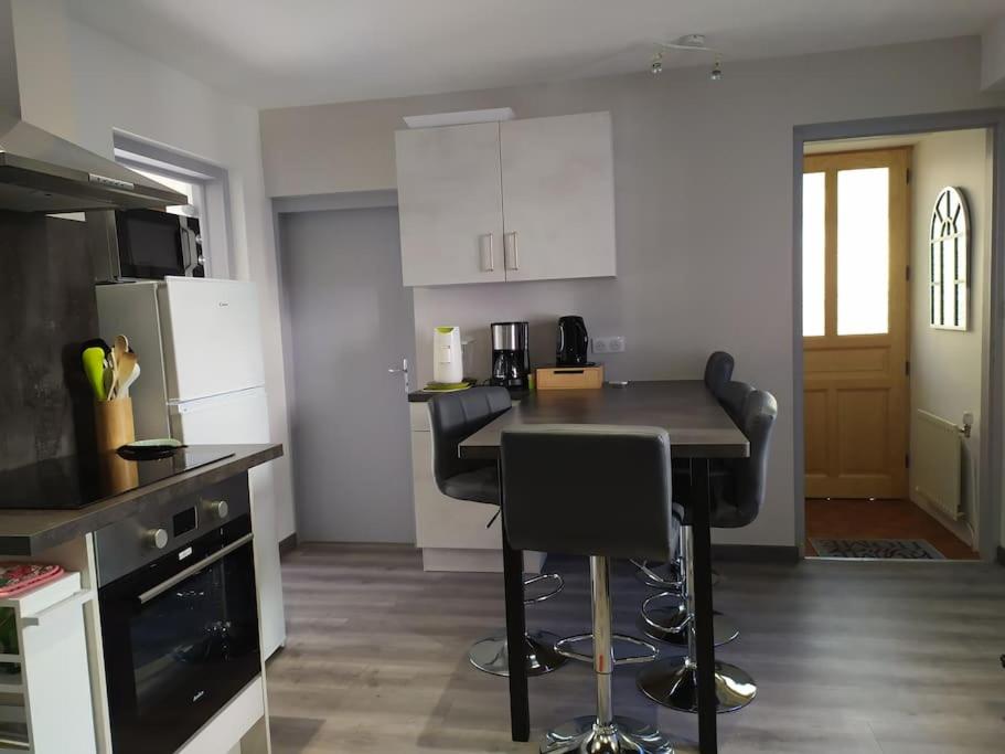 une cuisine avec une table et des chaises dans une pièce dans l'établissement Chez Vovone 3 étoiles clévacances, à Saulxures-sur-Moselotte