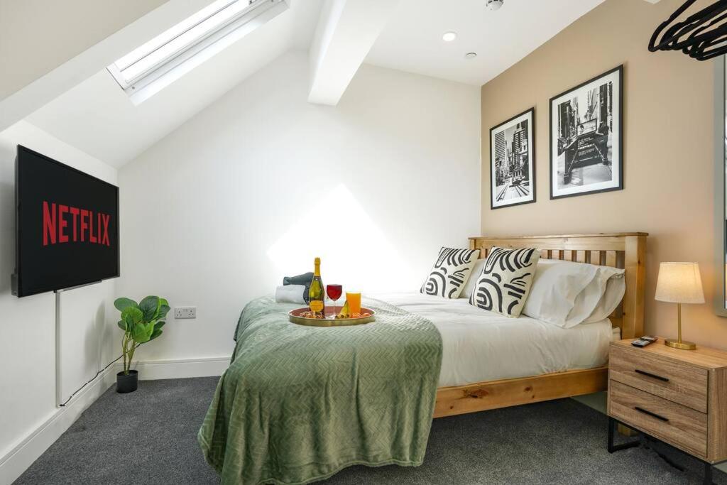 a bedroom with a bed and a table with drinks on it at Central Buckingham Apartment #2 with Free Parking, Pool Table, Fast Wifi and Smart TV with Netflix by Yoko Property in Buckingham