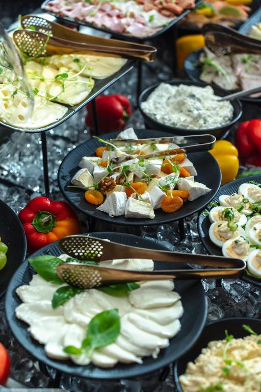 a bunch of plates of food on a buffet at Haffner Hotel & SPA Sopot - Destigo Hotels in Sopot