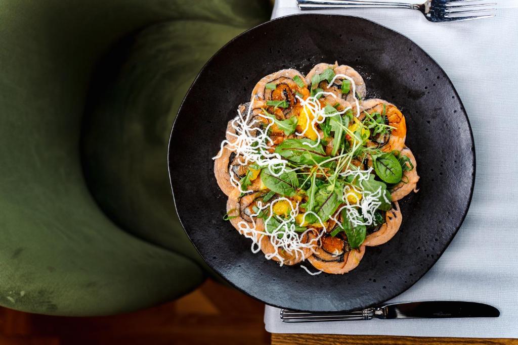 a plate of food on top of a table at Haffner Hotel & SPA Sopot - Destigo Hotels in Sopot