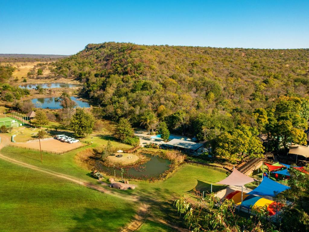 an aerial view of a park with a lake at Waterberg Game Park in Mokopane