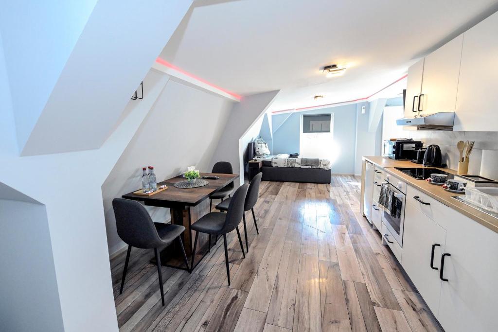 a kitchen and dining room with a table and chairs at Happy -Apartments in Magdeburg