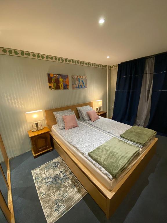 a bedroom with a bed with two pillows on it at Apartament Dyrektorski in Stalowa Wola