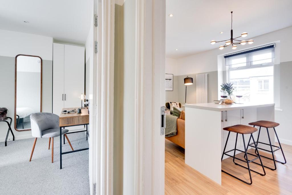 a kitchen and living room with a table and chairs at Urban Oasis by Keystone in Newport