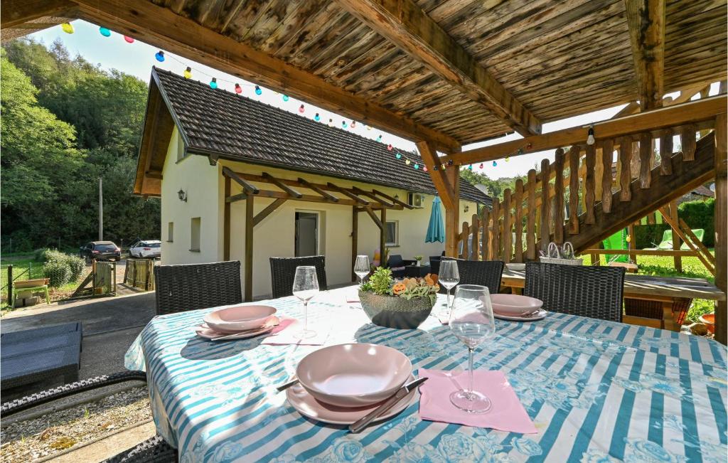 a table with plates and napkins on a patio at Stunning Home In Varazdinske Toplice With Kitchenette in Varaždinske Toplice