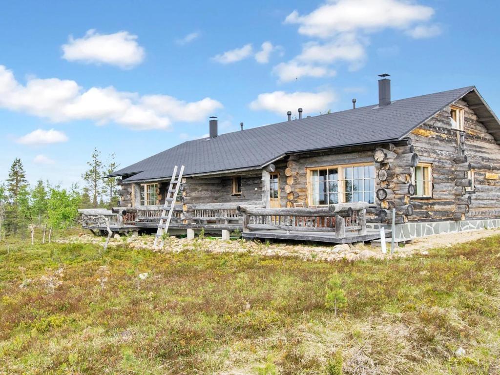 een grote blokhut met een veranda en een huis bij Holiday Home Kelopirtti a by Interhome in Saariselkä