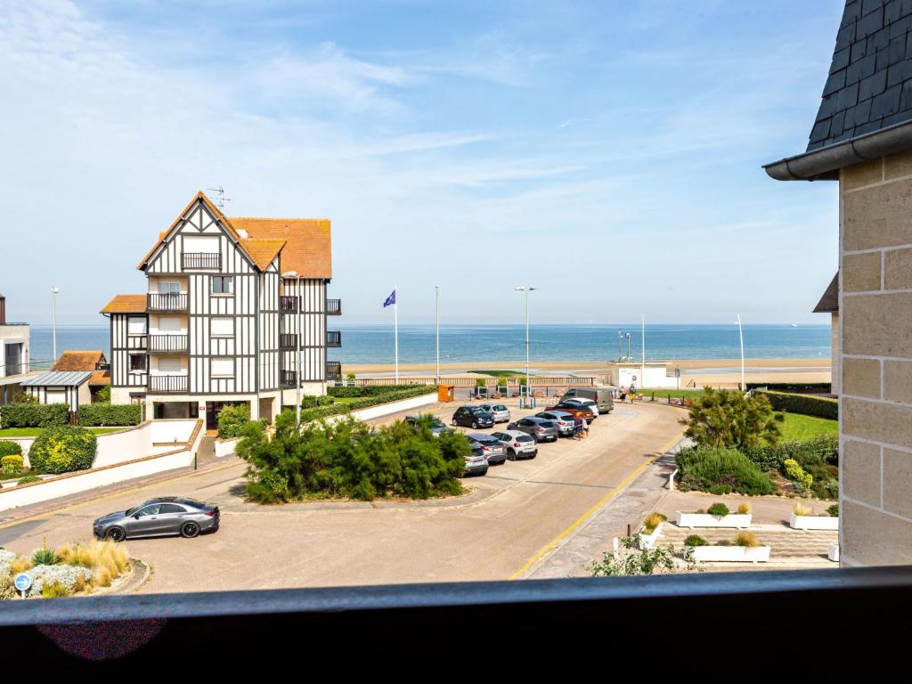 vistas a un aparcamiento con un edificio y a la playa en Apartment Cap Cabourg-31 by Interhome en Cabourg
